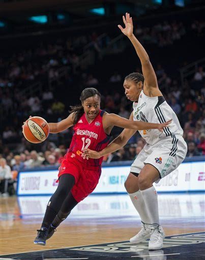 Ivory Latta of Washington Mystics pushes past Liberty player to nail three pointer