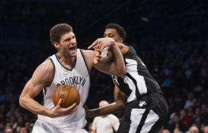 Brooklyn Nets center Brook Lopez defending off Miami Heat player