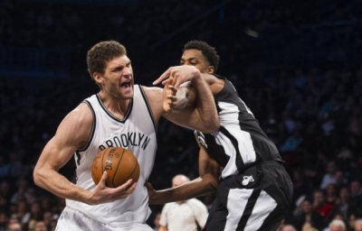 Brooklyn Nets center Brook Lopez defending off Miami Heat player