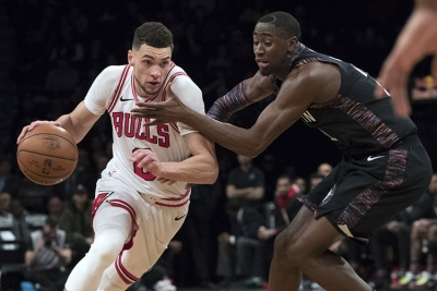 Brooklyn Nets guard Caris LeVert (right) defending against Chicago Bulls guard Zach LaVine