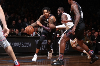 Brooklyn Nets guard D’Angelo Russell in traffic between two Philadelphia 76ers players and Nets Ed Davis (far right) looking on in Game 3 of the Eastern Conference NBA Playoffs on April 18, 2019, at the Barclays Center in Brooklyn, NY.