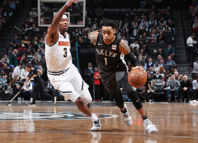 Brooklyn Nets point guard D’Angelo Russell whizzes by Denver Nuggets forward Torrey Craig at Barclays Center on February 6, 2019. Brooklyn Nets defeated the Denver Nuggets 135-130  