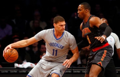 Brooklyn Nets center Brook Lopez trying to get past Atlanta Hawks center Dwight Howard