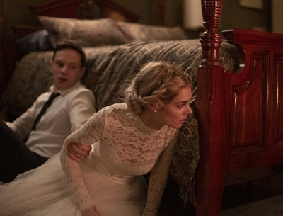 Mark O&#039;Brien (l) and Samara Weaver, the primary actors in the movie, Ready or Not, hiding next to a bed in a deadly game of hide and seek.