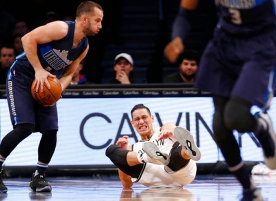 Brooklyn Nets point guard Jeremy Lin goes down with a sprained right ankle at 4:36 mark in first quarter in game against Dallas Mavericks on Sunday, March 19, 2017  