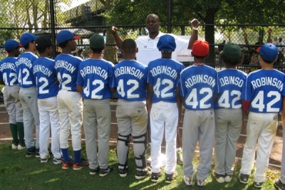 Maurice Ballard talking with members of his youth baseball team