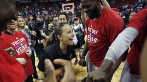 Becky Hammon (center), first woman to coach an NBA Summer League team, also became the first woman to win an NBA Summer League championship. 