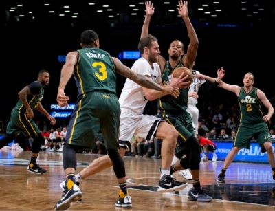 Photo: Bojan Bogdanovic Brooklyn Nets guard drives past Utah defenders Trey Burke and Rodney Hood